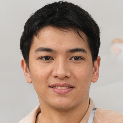 Joyful asian young-adult male with short  brown hair and brown eyes