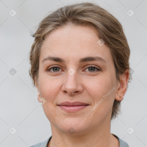 Joyful white adult female with short  brown hair and grey eyes