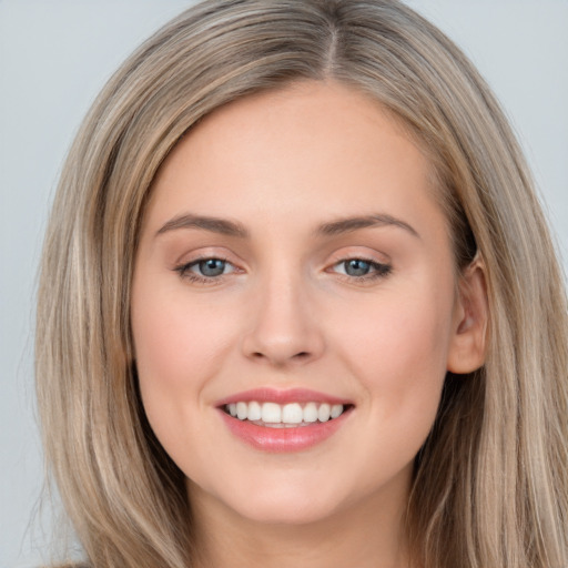 Joyful white young-adult female with long  brown hair and grey eyes