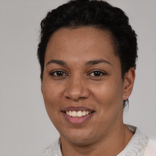 Joyful latino young-adult female with short  black hair and brown eyes
