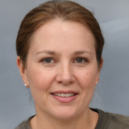 Joyful white adult female with short  brown hair and grey eyes