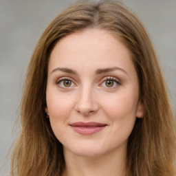 Joyful white young-adult female with long  brown hair and green eyes