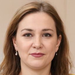 Joyful white adult female with long  brown hair and brown eyes