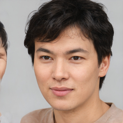 Joyful white young-adult male with medium  brown hair and brown eyes
