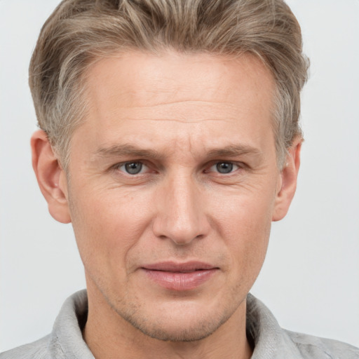 Joyful white adult male with short  brown hair and grey eyes