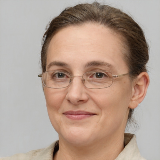 Joyful white adult female with medium  brown hair and brown eyes