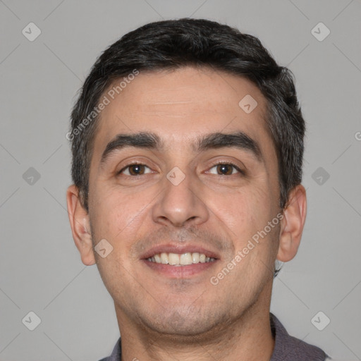 Joyful white young-adult male with short  black hair and brown eyes