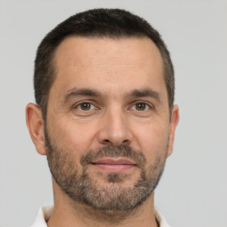 Joyful white adult male with short  brown hair and brown eyes