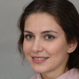 Joyful white adult female with medium  brown hair and brown eyes