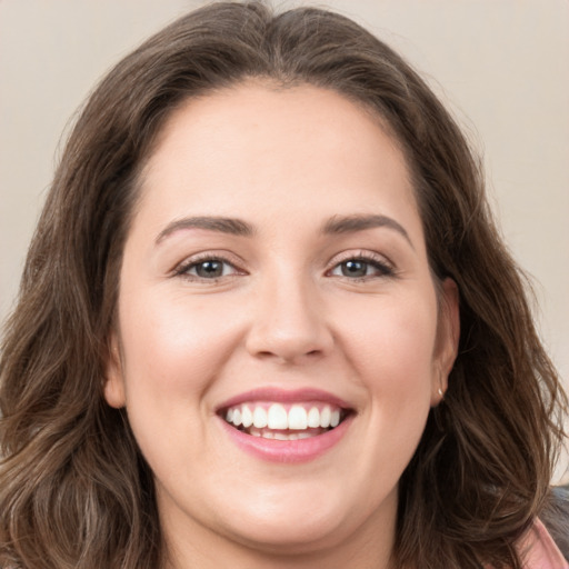 Joyful white young-adult female with long  brown hair and green eyes