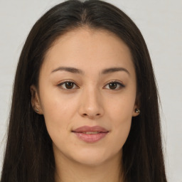 Joyful asian young-adult female with long  brown hair and brown eyes