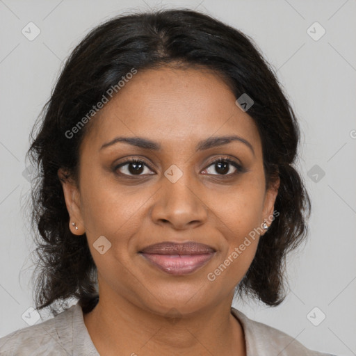 Joyful black adult female with medium  brown hair and brown eyes