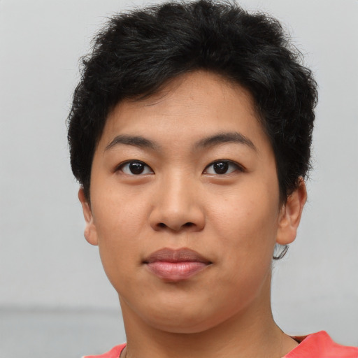 Joyful asian young-adult female with short  brown hair and brown eyes