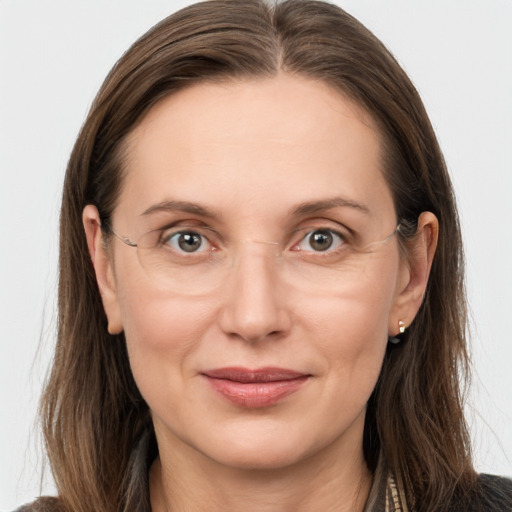 Joyful white adult female with long  brown hair and grey eyes