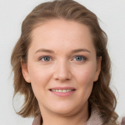 Joyful white young-adult female with long  brown hair and blue eyes