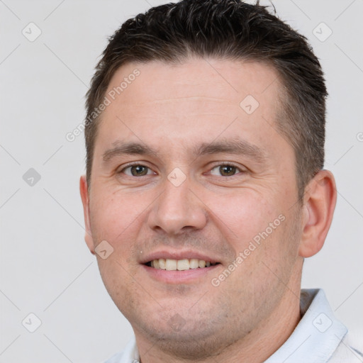 Joyful white young-adult male with short  brown hair and brown eyes