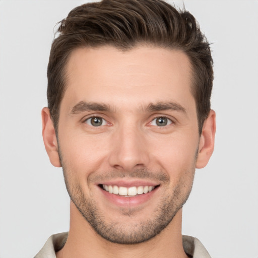 Joyful white young-adult male with short  brown hair and brown eyes