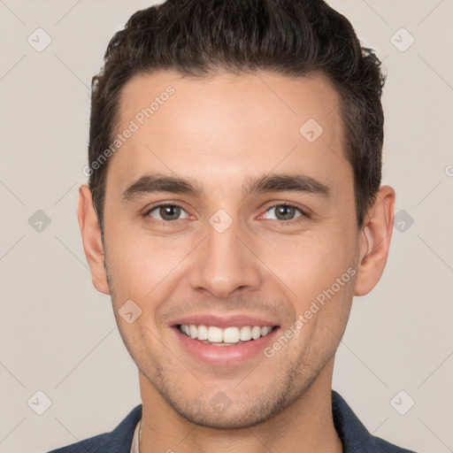 Joyful white young-adult male with short  brown hair and brown eyes