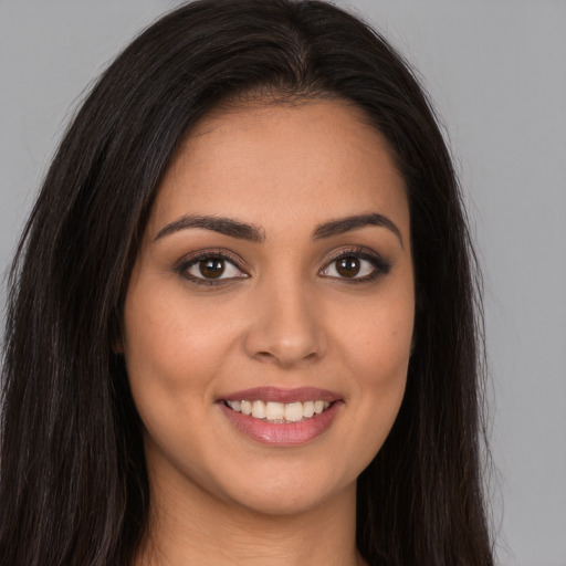 Joyful white young-adult female with long  brown hair and brown eyes