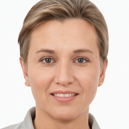 Joyful white young-adult female with short  brown hair and grey eyes