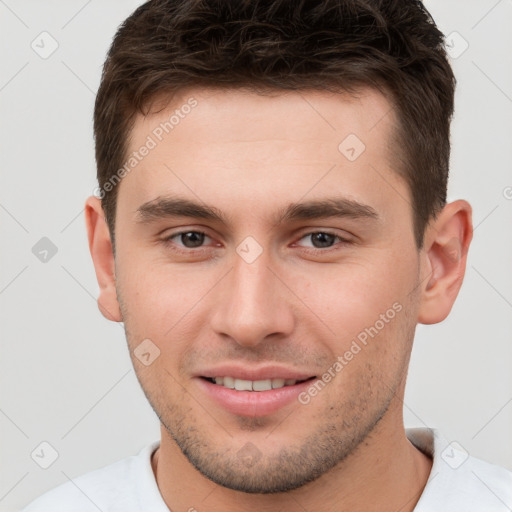 Joyful white young-adult male with short  brown hair and brown eyes