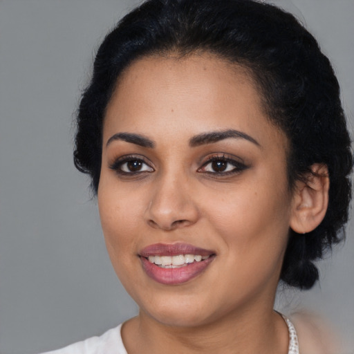 Joyful latino young-adult female with medium  black hair and brown eyes
