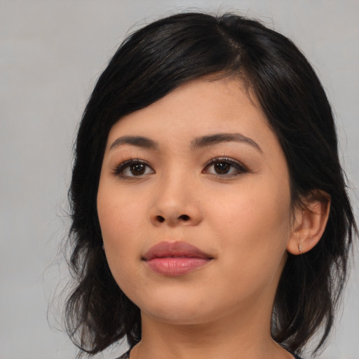 Joyful asian young-adult female with medium  black hair and brown eyes