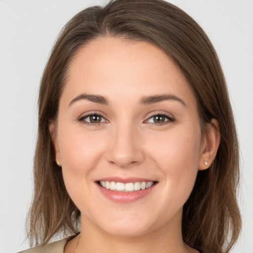 Joyful white young-adult female with medium  brown hair and grey eyes