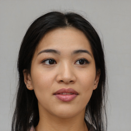 Joyful asian young-adult female with long  black hair and brown eyes