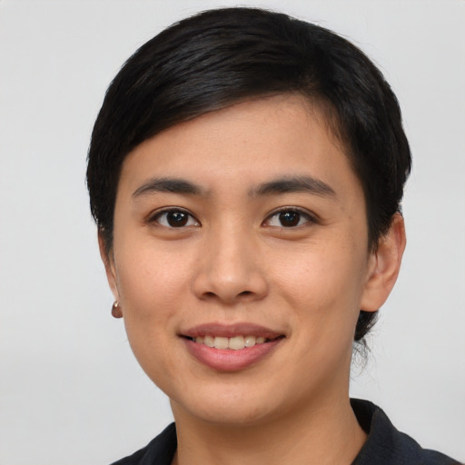 Joyful asian young-adult female with short  black hair and brown eyes