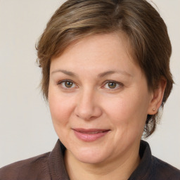 Joyful white adult female with medium  brown hair and brown eyes