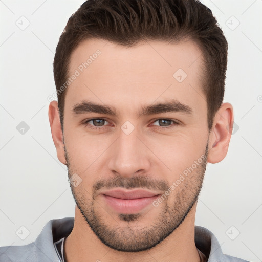 Joyful white young-adult male with short  brown hair and brown eyes