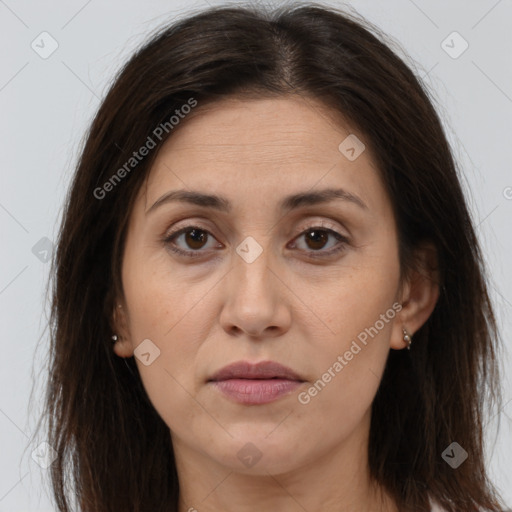 Joyful white adult female with long  brown hair and brown eyes