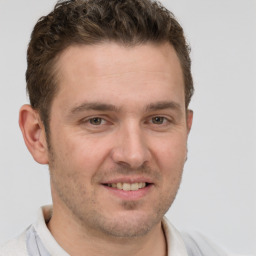 Joyful white adult male with short  brown hair and grey eyes