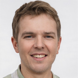 Joyful white young-adult male with short  brown hair and grey eyes