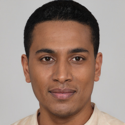Joyful latino young-adult male with short  black hair and brown eyes