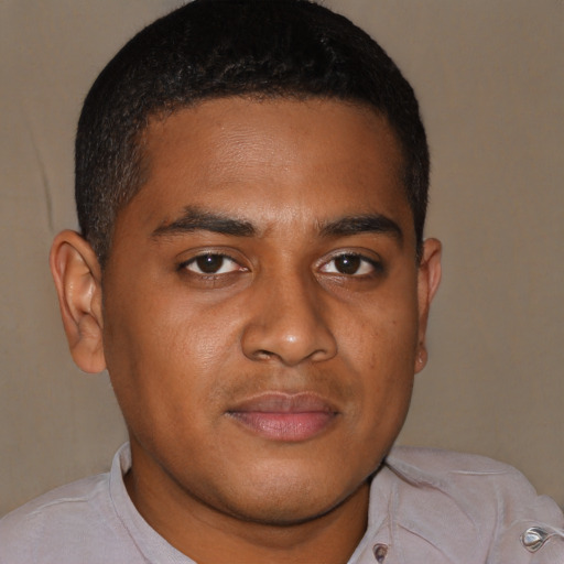 Joyful black young-adult male with short  brown hair and brown eyes