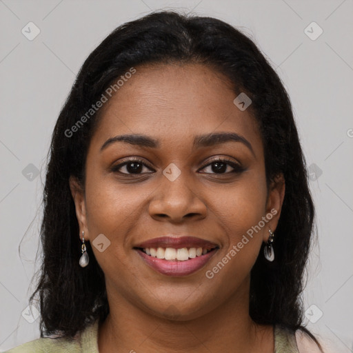 Joyful black young-adult female with long  brown hair and brown eyes