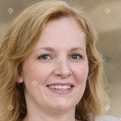 Joyful white adult female with medium  brown hair and blue eyes