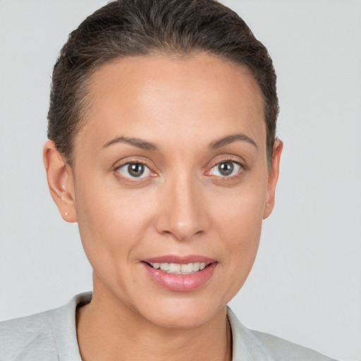 Joyful white young-adult female with short  brown hair and brown eyes