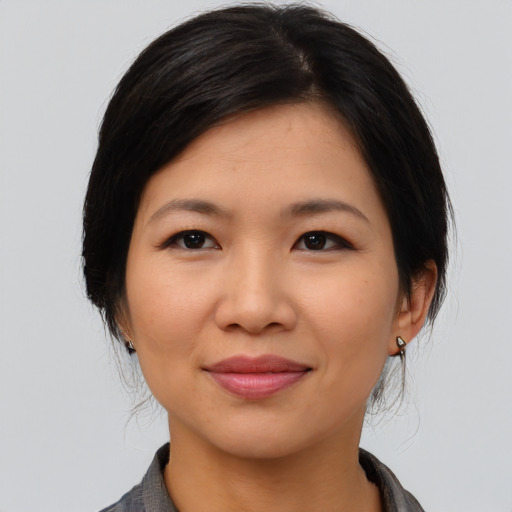 Joyful asian young-adult female with medium  black hair and brown eyes