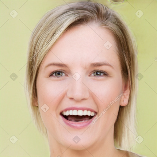 Joyful white young-adult female with medium  brown hair and blue eyes