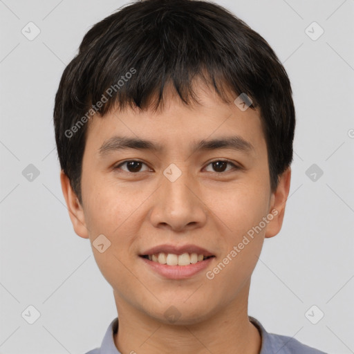 Joyful asian young-adult male with short  brown hair and brown eyes