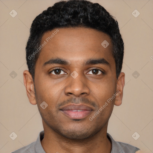 Joyful black young-adult male with short  black hair and brown eyes