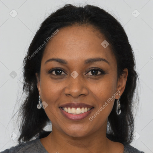 Joyful black young-adult female with long  brown hair and brown eyes