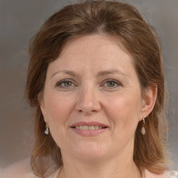 Joyful white adult female with medium  brown hair and grey eyes