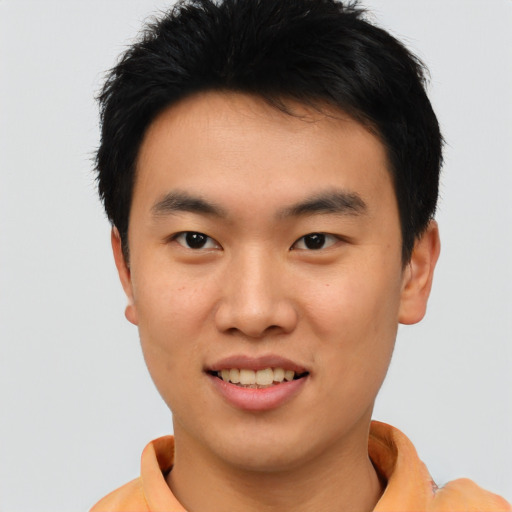 Joyful asian young-adult male with short  black hair and brown eyes