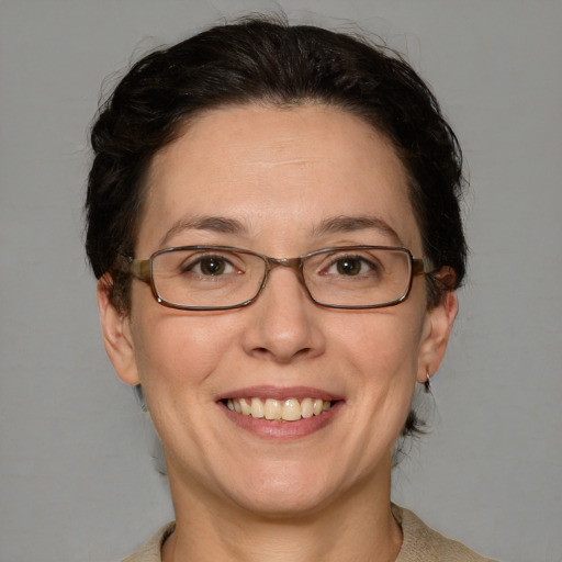 Joyful white adult female with short  brown hair and blue eyes