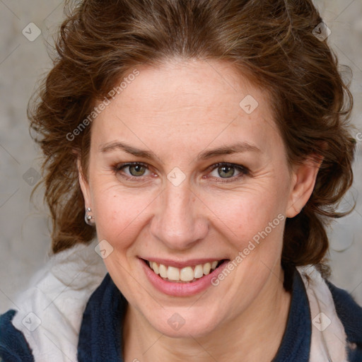 Joyful white adult female with medium  brown hair and blue eyes