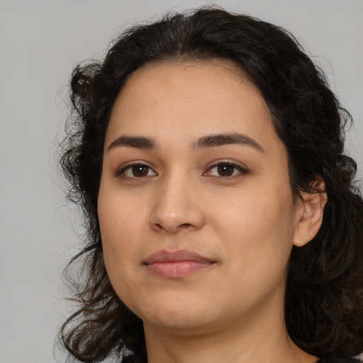 Joyful latino young-adult female with medium  black hair and brown eyes